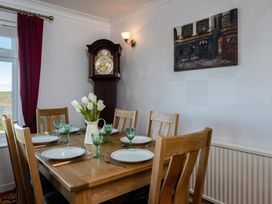 A dining room with a table set for dinner at Hillview in Polzeath