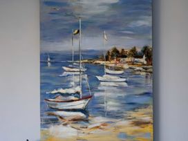 A painting of boats on water at Hillview in Polzeath