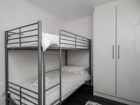 A bedroom with a bunk bed and a wardrobe at Hillview in Polzeath
