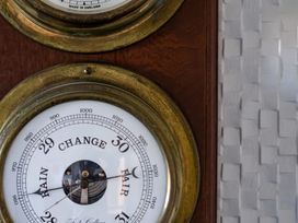 A barometer on a wooden surface at Hillview in Polzeath