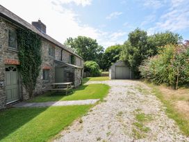 An outdoor space with a house and garage at Orchard Cottage in Polzeath
