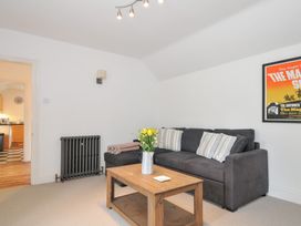 A living room with a sofa and coffee table at Orchard Cottage in Polzeath
