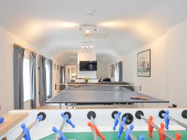 A recreation room with a table tennis table and foosball table at Orchard Cottage in Polzeath