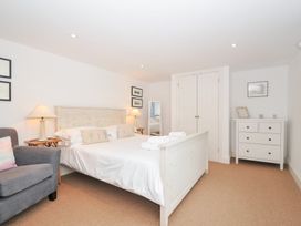 A bedroom with a bed and bedside lamps at Orchard Cottage in Polzeath