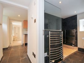 A bathroom featuring a shower and radiator at Orchard Cottage Polzeath