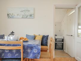 A dining room with a table set for tea at Hillcroft Bungalow Daymer Bay