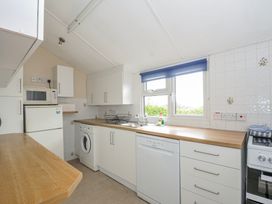 A kitchen with appliances and countertop at Hillcroft Bungalow in Daymer Bay