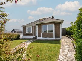 A house with a garden and pathway at Hillcroft Bungalow Daymer Bay