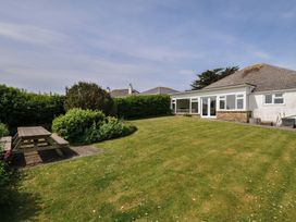 A garden with a picnic table and chairs at Hillcroft Bungalow Daymer Bay