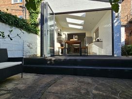 A kitchen with an open sliding door and outdoor steps at South Bay House in Scarborough