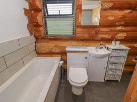 A bathroom with a bathtub, toilet, and sink at Cedar Cabin at Salford Court Farm Fishing Cabins Near Clifton Upon Teme