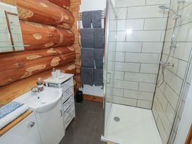 A bathroom with a shower and sink at Cedar Cabin at Salford Court Farm Fishing Cabins near Clifton Upon Teme
