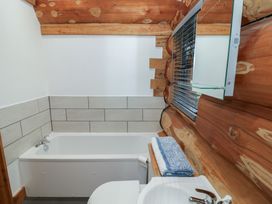 A bathroom with a bathtub, sink, and toilet at Cedar Cabin at Salford Court Farm Fishing Cabins near Clifton Upon Teme