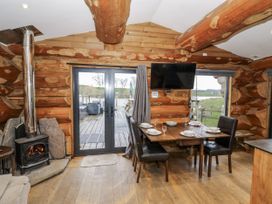 A dining room with a table and chairs at Douglas Cabin at Salford Court Farm Fishing Cabins near Clifton Upon Teme