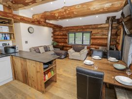 A living room with a kitchen island and dining area at Douglas Cabin at Salford Court Farm Fishing Cabins near Clifton Upon Teme