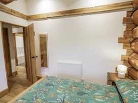 A bedroom with a bed and radiator at Douglas Cabin at Salford Court Farm Fishing Cabins near Clifton Upon Teme