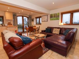 A living room with a sofa and dining area at Brush and Boot in York