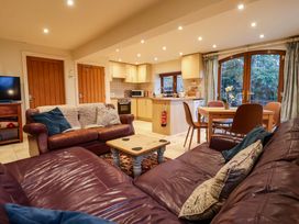 A living room with a sofa and dining area at Brush and Boot in York
