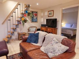 A living room with a sofa and staircase at Brush and Boot in York