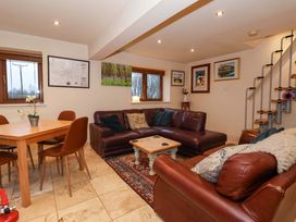 A living room with a dining table and sofa at Brush and Boot in York