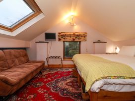 A bedroom with a bed and sofa at Brush and Boot in York