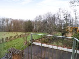 An outdoor area with trees and a bench at Brush and Boot in York