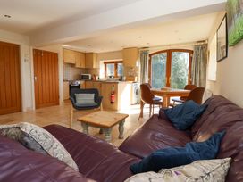 A living room with a sofa and dining area at Brush and Boot in Stittenham near York