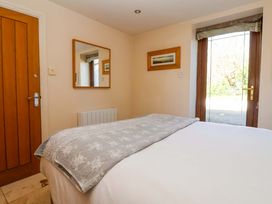 A bedroom with a bed and a door at Brush and Boot in Stittenham near York