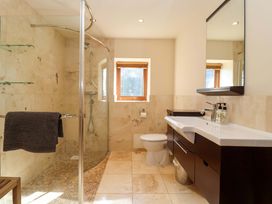 A bathroom with shower, toilet, sink and mirror at Brush and Boot in Stittenham near York