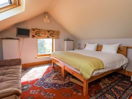 A bedroom with a bed and sofa at Brush and Boot in Stittenham near York