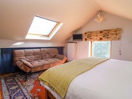 A bedroom with a sofa and television at Brush and Boot in Stittenham near York