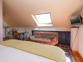 A bedroom with a sofa and table at Brush and Boot in Stittenham near York