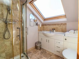 A bathroom with a shower and sink at Brush and Boot in Stittenham near York