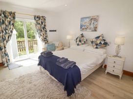 A bedroom with a bed and side tables at Charlecote House in Saundersfoot