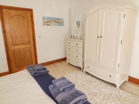 A bedroom with a wardrobe and chest of drawers at Charlecote House in Saundersfoot