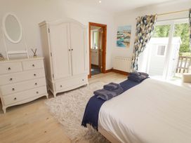 A bedroom with a wardrobe and chest of drawers at Charlecote House Saundersfoot