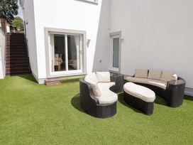 An outdoor area with seating and steps at Charlecote House in Saundersfoot