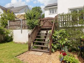 A garden with stairs leading to a patio at Charlecote House in Saundersfoot