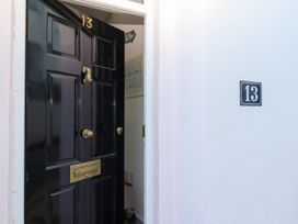 An entryway with a black door and house number at 13 Above Town in Dartmouth