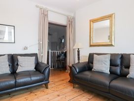A living room with sofas and a lamp at 13 Above Town Dartmouth