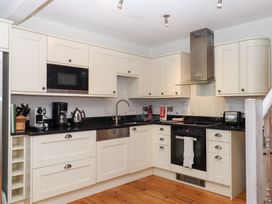 A kitchen with appliances and cabinetry at 13 Above Town Dartmouth