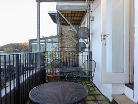A balcony with tables and chairs at 13 Above Town in Dartmouth