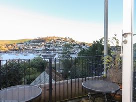 A balcony with seating overlooking a harbor at 13 Above Town Dartmouth