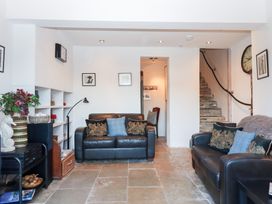 A living room with sofas and a staircase at 13 Above Town in Dartmouth