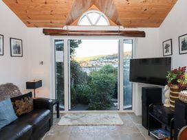 A snug with a sofa and television at 13 Above Town in Dartmouth