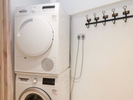 A washing machine and dryer in a laundry room at 13 Above Town in Dartmouth