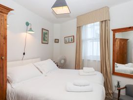 A bedroom with two beds and decorative items at 13 Above Town in Dartmouth