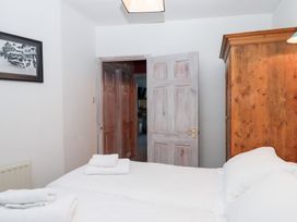 A bedroom with a wardrobe and towels on a bed at 13 Above Town in Dartmouth