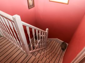 A staircase with a balustrade and patterned carpet at 13 Above Town in Dartmouth