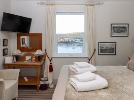 A bedroom with a bed, mirror, and television at 13 Above Town in Dartmouth